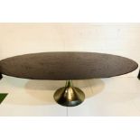 Large oval top dining table on silver coloured metal pedestal