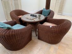 A group of four rattan chairs; and a rattan glass topped glass table
