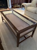 Rectangular display/coffee table with bevelled edge glass and rising lid