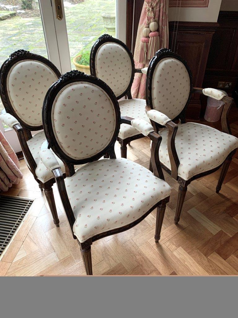 Set of four carved and upholstered elbow chairs