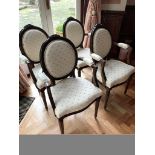 Set of four carved and upholstered elbow chairs