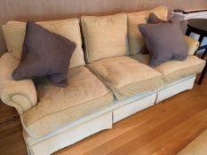 Light gold upholstered three seat sofa