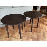 Two dark brown circular occasional tables on four block legs