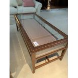 Rectangular display/coffee table with bevelled edge glass and rising lid