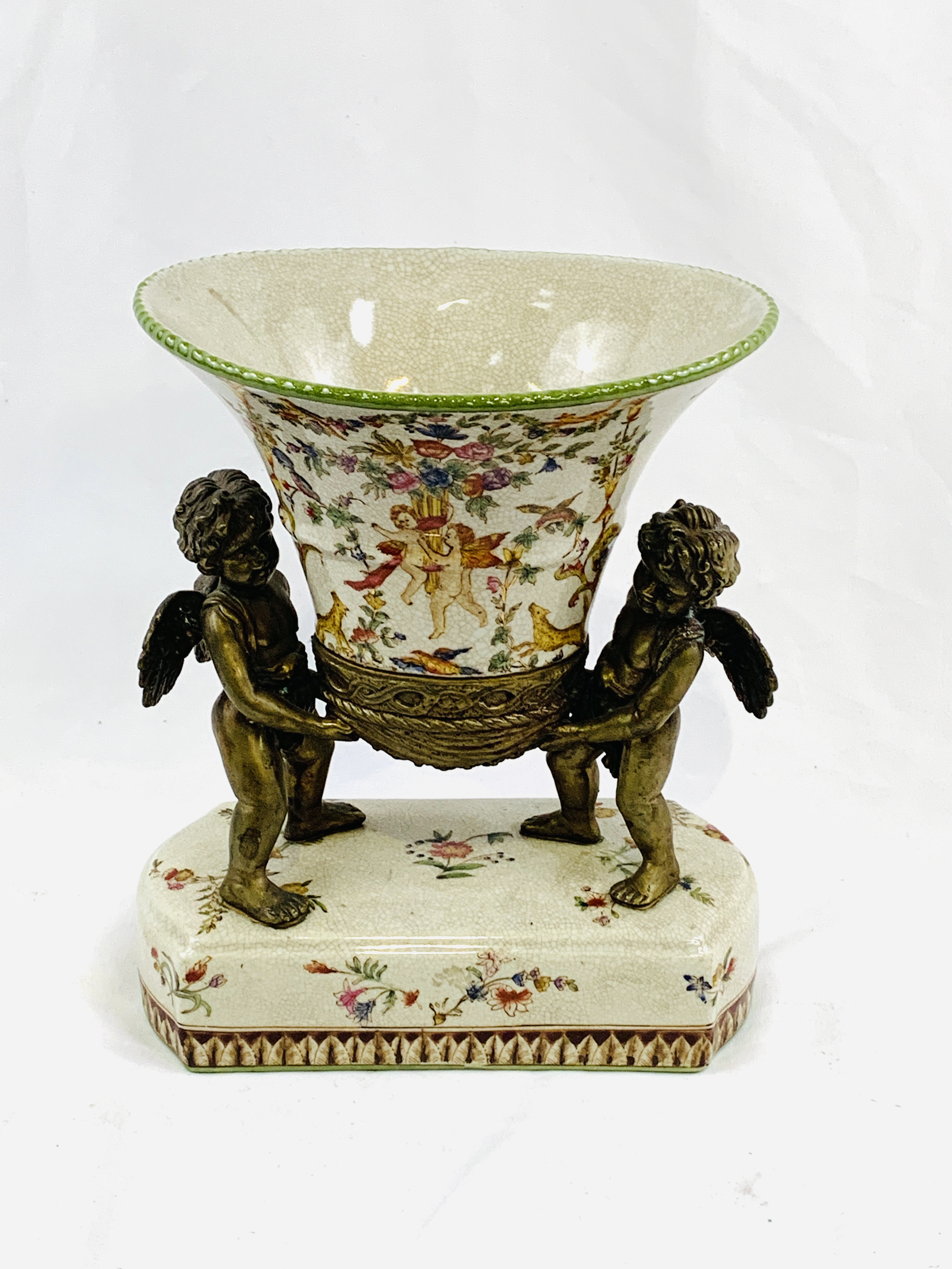 Decorative ceramic centrepiece with mounted ormolu cherubs.