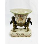 Decorative ceramic centrepiece with mounted ormolu cherubs.