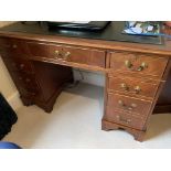 Mahogany pedestal desk together with a matching writing table