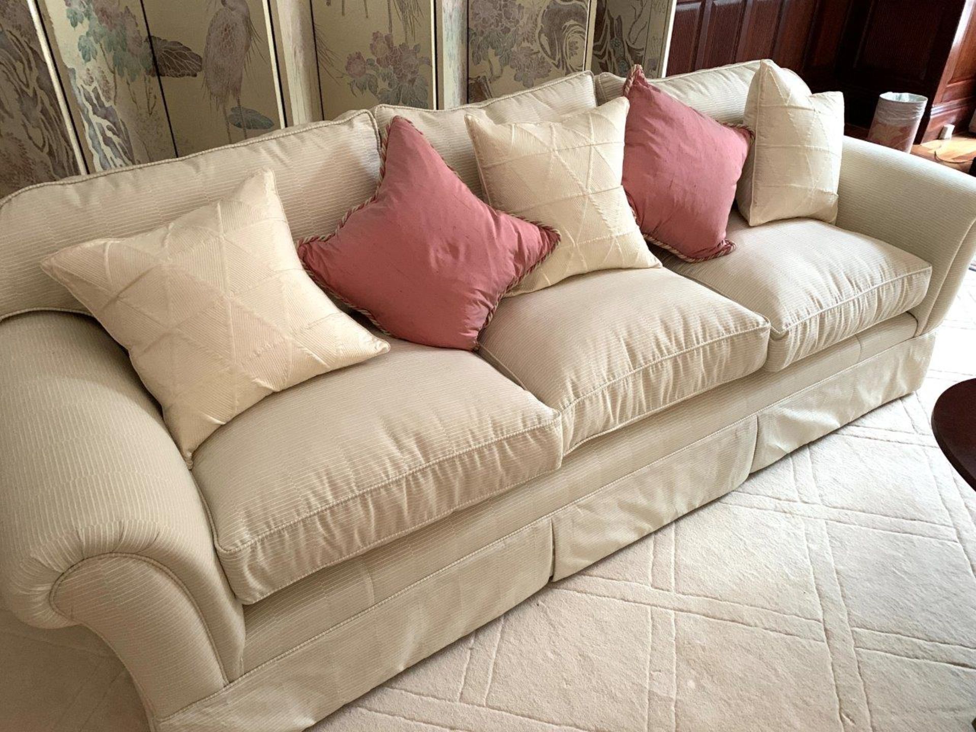 Cream cord effect upholstered three seat sofa, with feather filled cushions