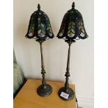 Two metal bedside lamps with stained glass shades