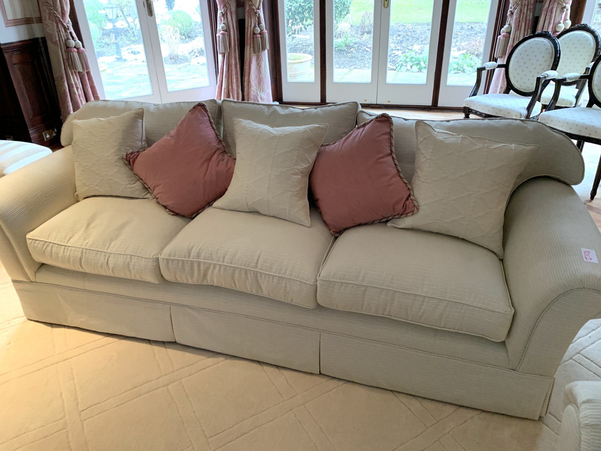 Cream cord effect upholstered three seat sofa, with feather filled cushions