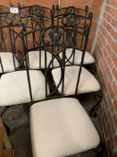 Six metal framed dining chairs with cream upholstered seats.