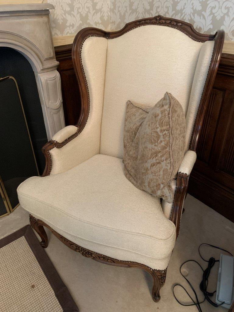 Carved and cream upholstered show wood French style armchair