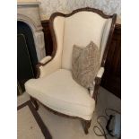 Carved and cream upholstered show wood French style armchair