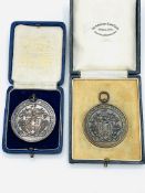 Two bronze medals with coat of arms and inscribed "The Worshipful Company of Farriers of London"