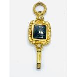 Gold watch key with green onyx centre