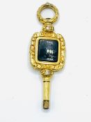 Gold watch key with green onyx centre