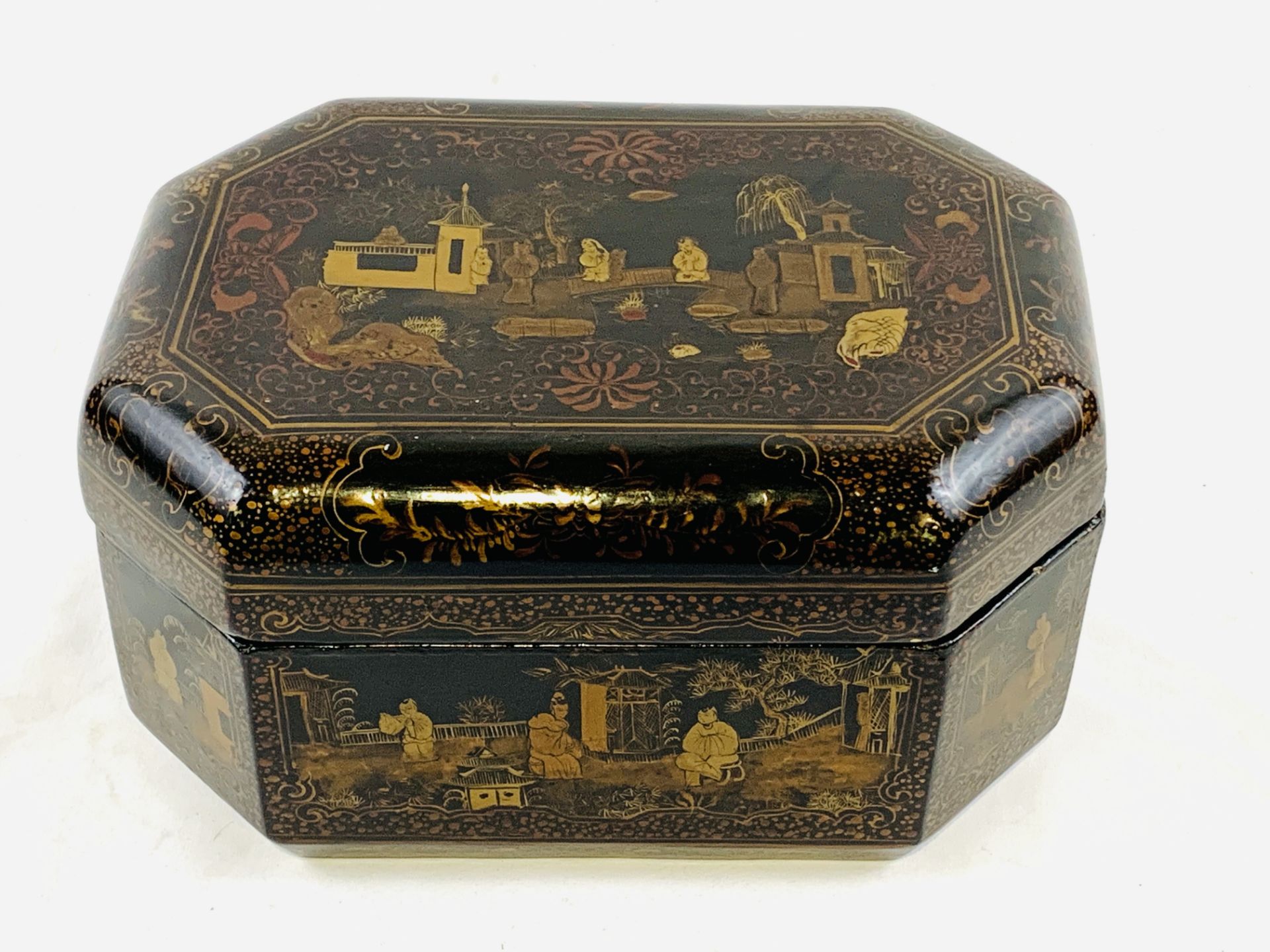 Black lacquered octagonal box with Chinese scenes to lid and panels