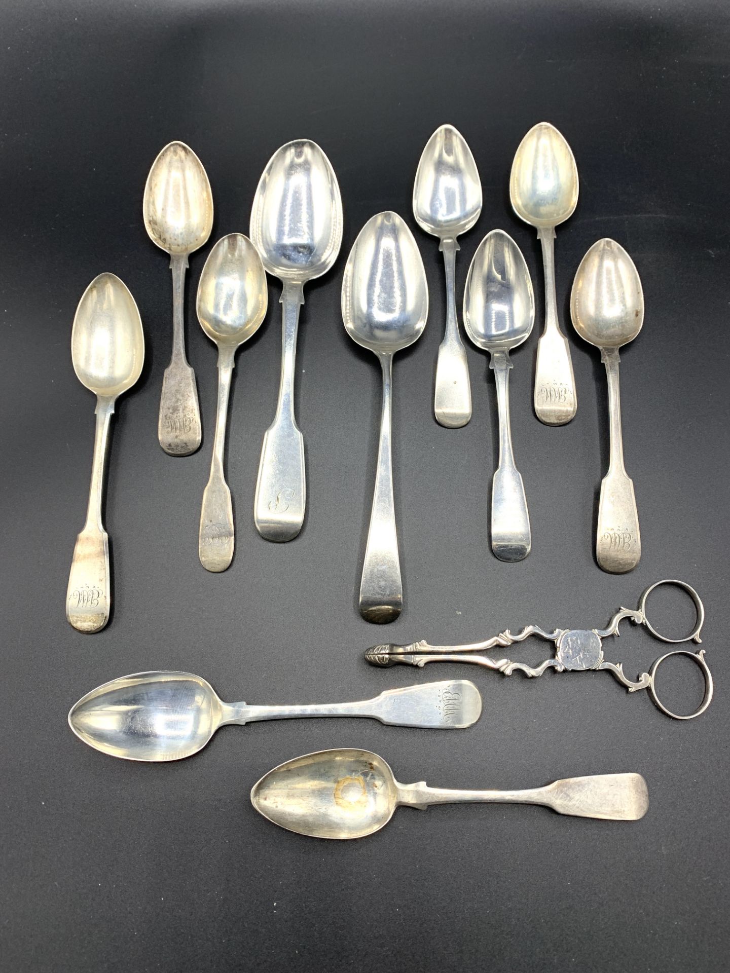 A pair of late 18th century silver sugar tongs, together with various Georgian silver spoons