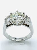 White gold diamond single stone ring with baguette shoulders, centre stone 2.35ct