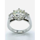White gold diamond single stone ring with baguette shoulders, centre stone 2.35ct
