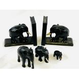 Pair of ebony Elephant bookends, together with a group of three graduated ebony Elephants