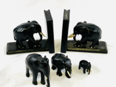 Pair of ebony Elephant bookends, together with a group of three graduated ebony Elephants