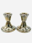 A pair of hallmarked silver low candlesticks