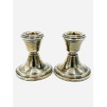 A pair of hallmarked silver low candlesticks