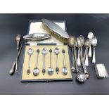 A quantity of hallmarked silver spoons and other items