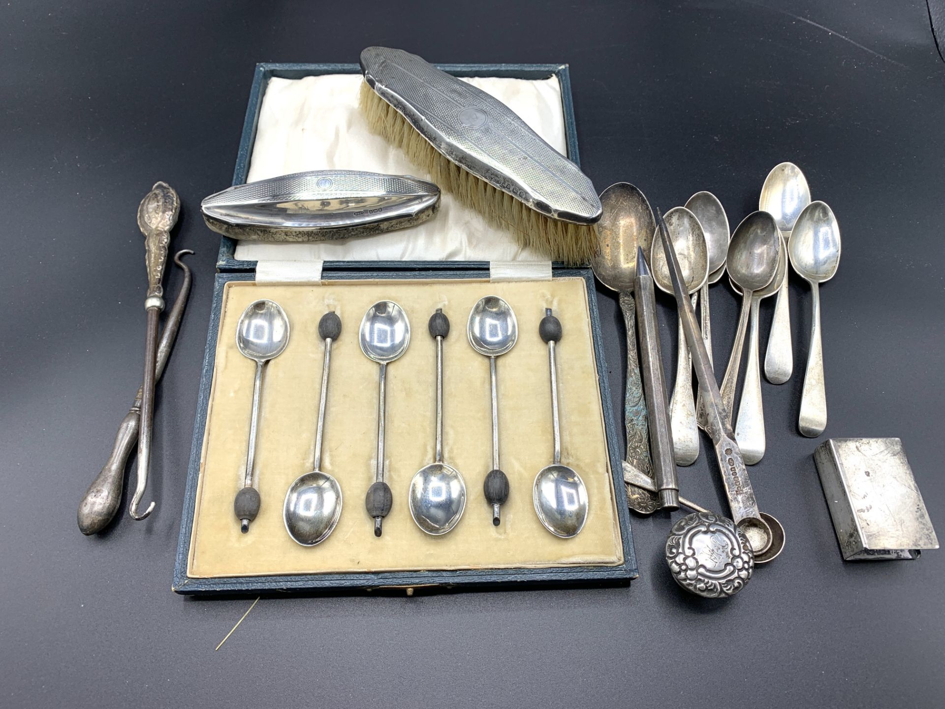 A quantity of hallmarked silver spoons and other items