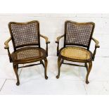 Pair of mahogany framed cane open arm chairs