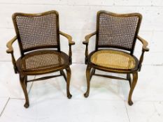 Pair of mahogany framed cane open arm chairs