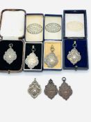 Five hallmarked silver medals by Fattorini & Sons Ltd.