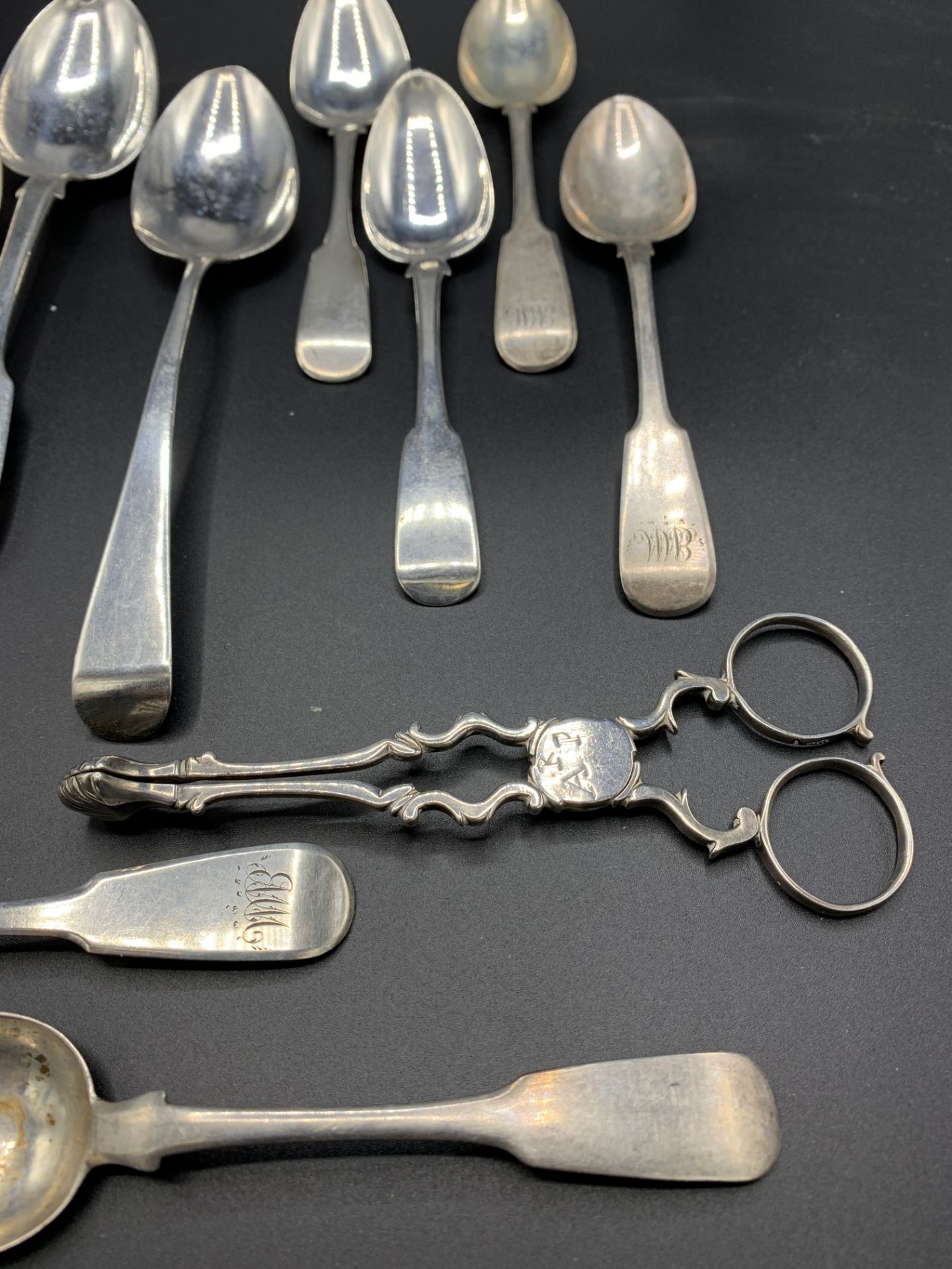 A pair of late 18th century silver sugar tongs, together with various Georgian silver spoons - Image 2 of 5