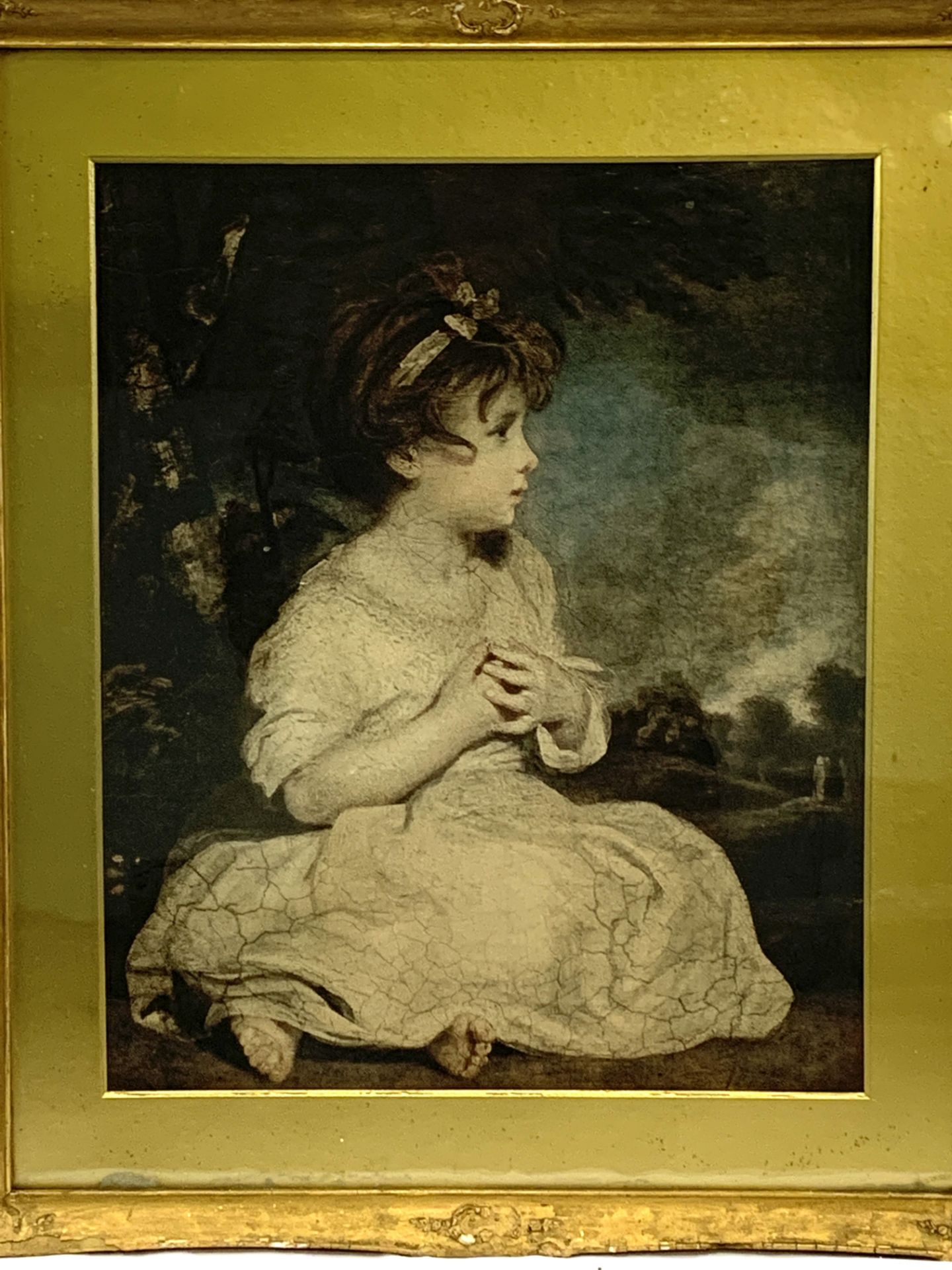 Gilt framed print of a girl sitting in a landscape