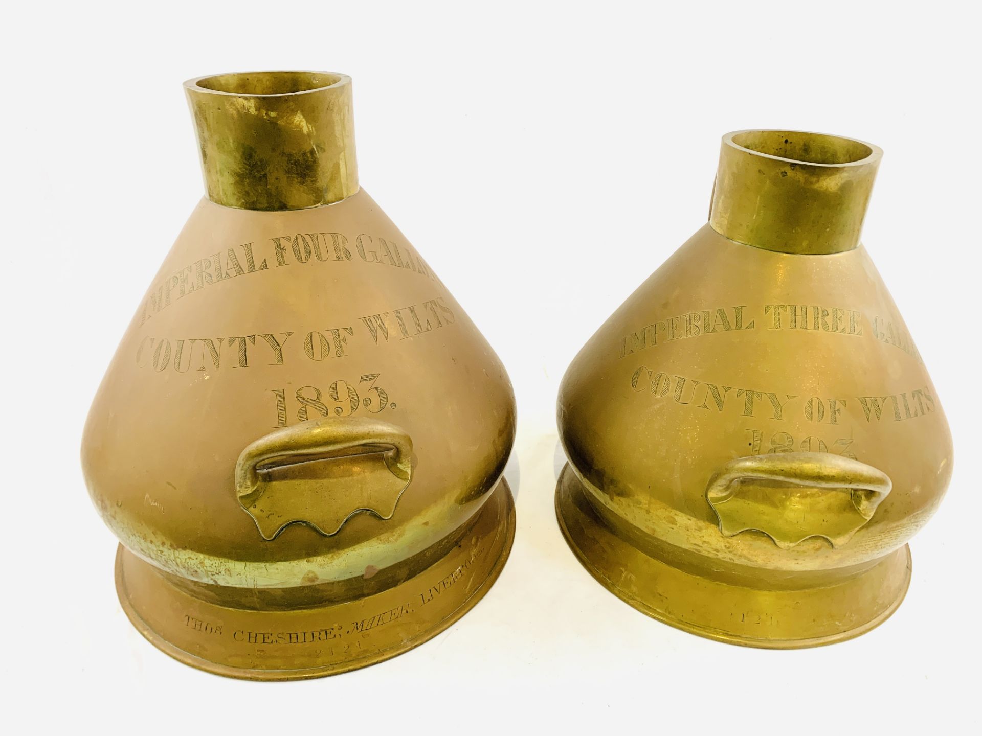 Two copper and brass measures: imperial 4 gallons and imperial 3 gallons