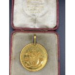 Gold coloured medal with coat of arms and inscribed "The Worshipful Company of Farriers of London"