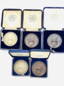 Two hallmarked silver medals and three bronze medals, inscribed Royal Counties Agricultural Society