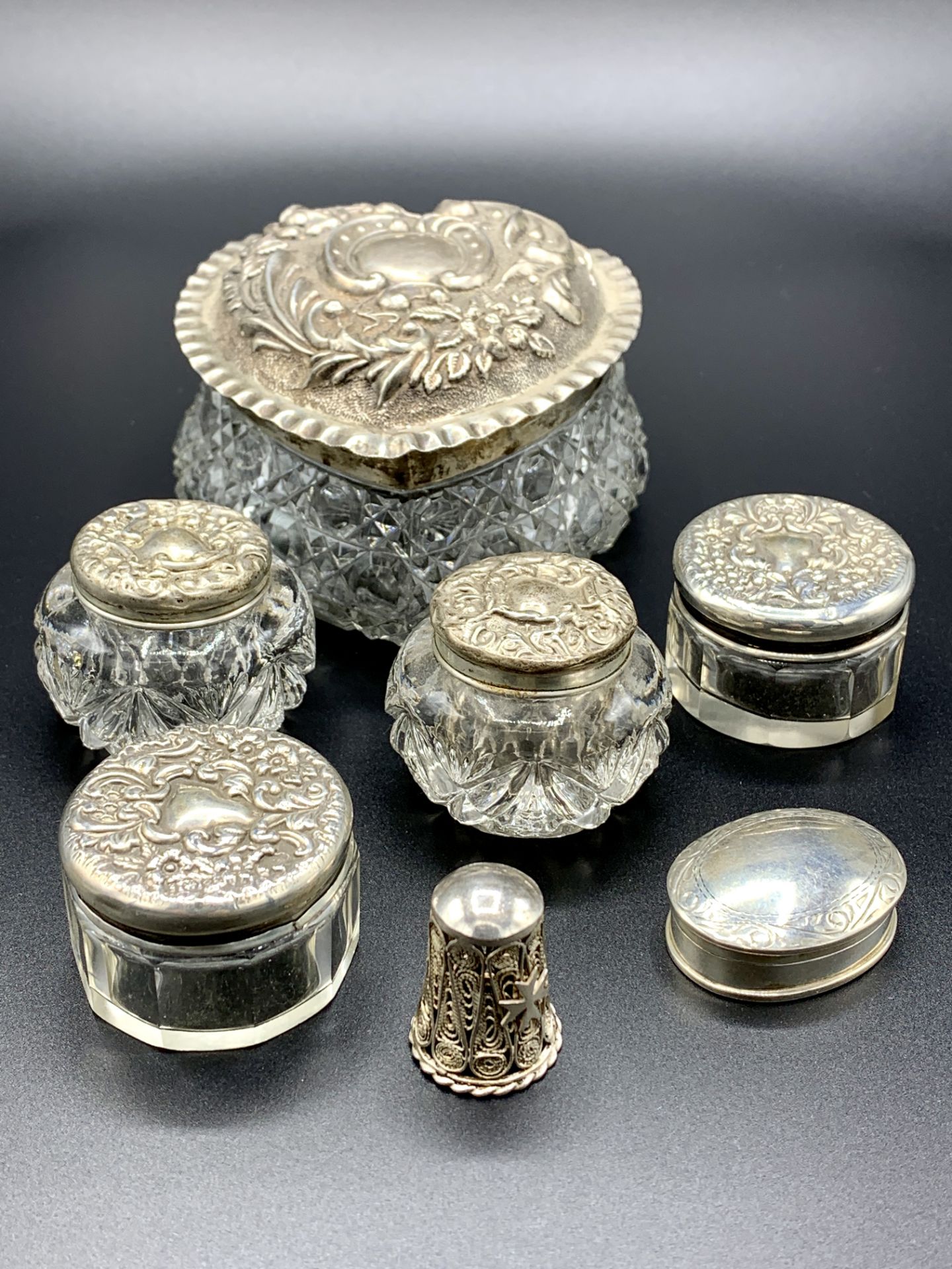 Six silver lidded glass pots