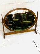 Mahogany veneer framed oval dressing table mirror on a solid mahogany stand.