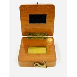A brass inch in fitted wooden box, dated 1891.
