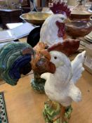 Three ceramic chicken figures and a metal cockerel