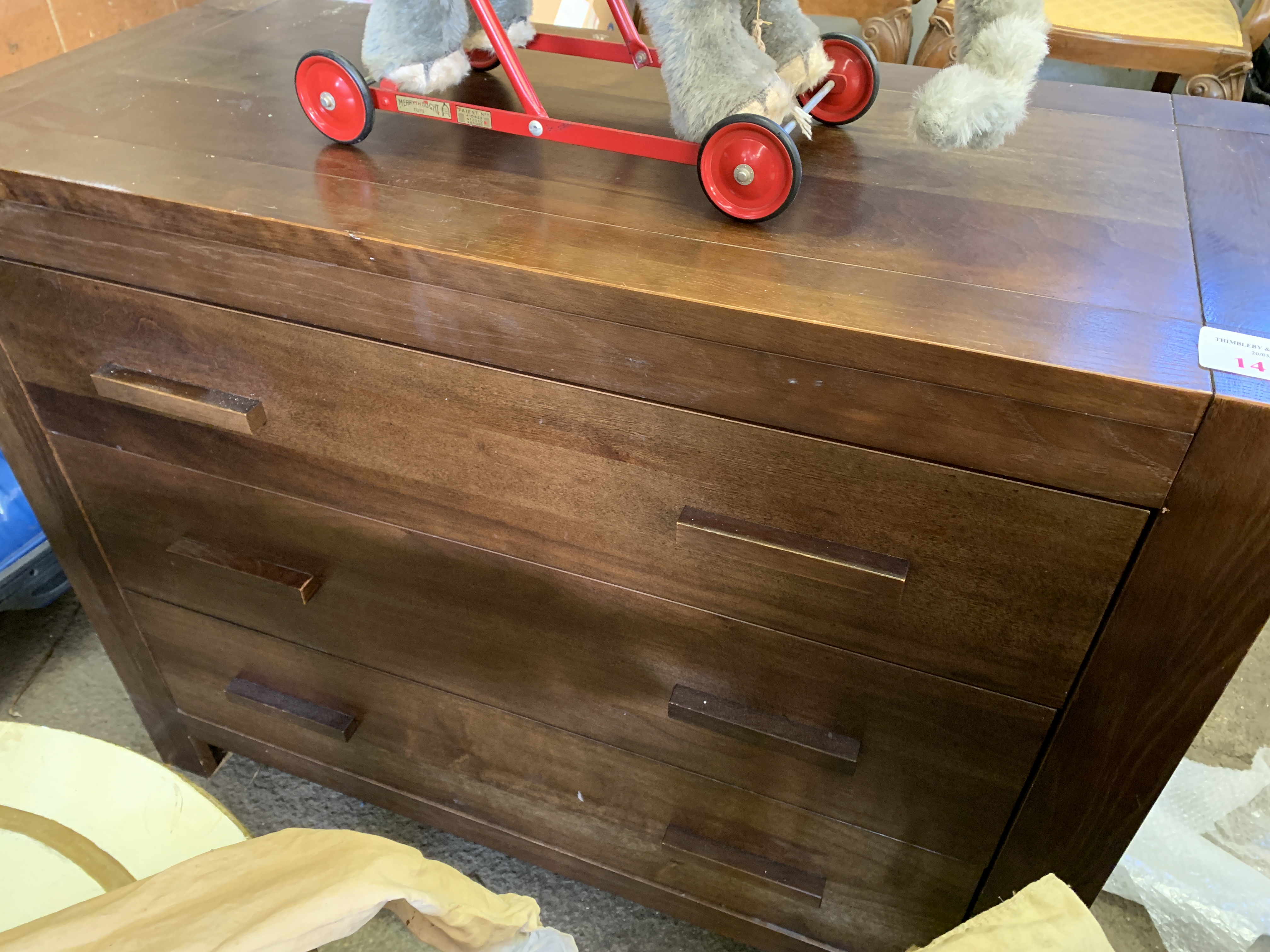 Stained laminate chest of three drawers.