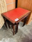 Nest of three mahogany tables with red leather skivers