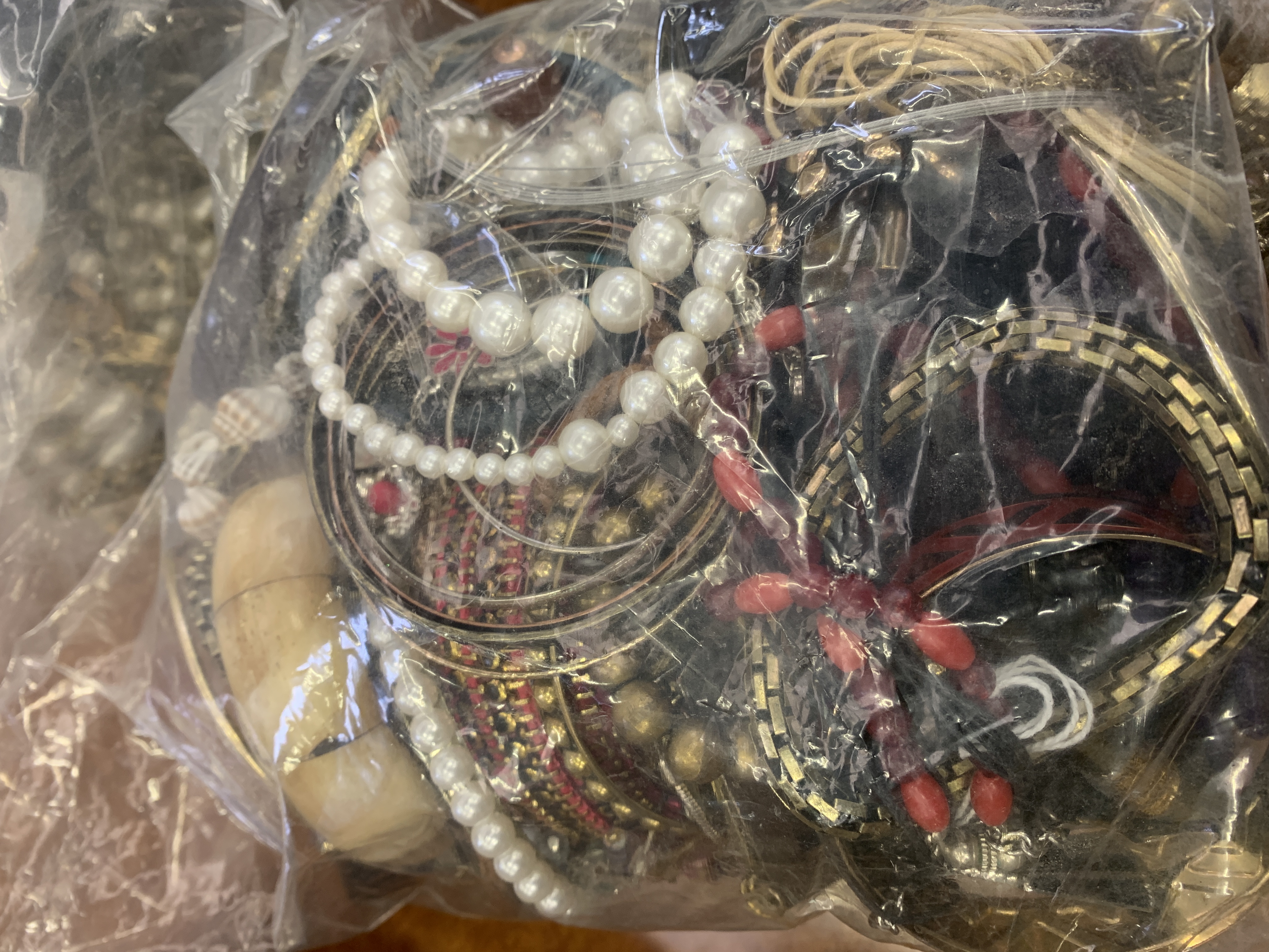 Three bags of costume jewellery and watches