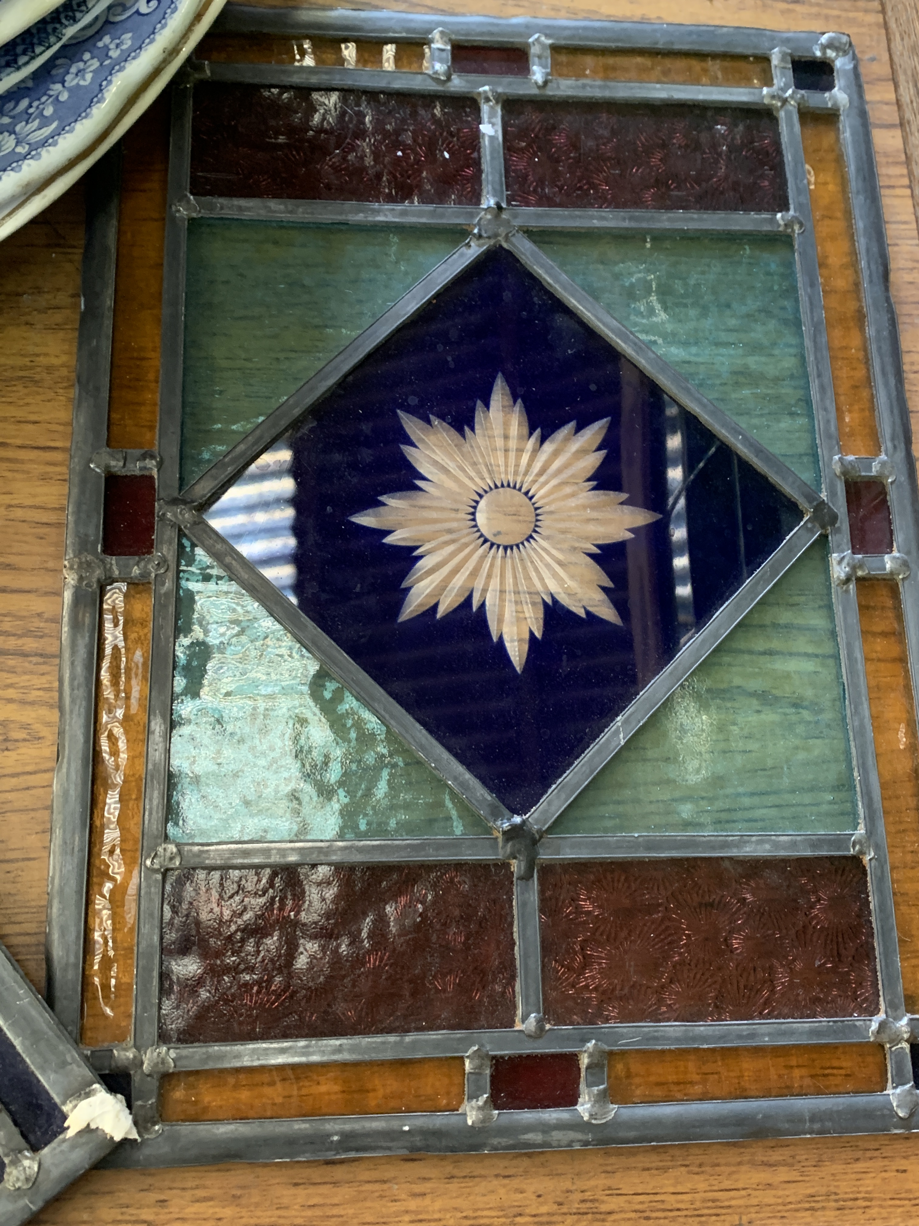 Two panels of stained glass; together with an oak framed green tiled splashback. - Image 2 of 4