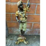 Figural carved wood lamp standard in the form of a boy in Middle Eastern clothing.