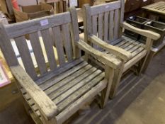 Two teak slatted garden armchairs and two teak low tables