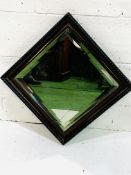 Carved decorative wood framed mirror with double bevelled edge glass.