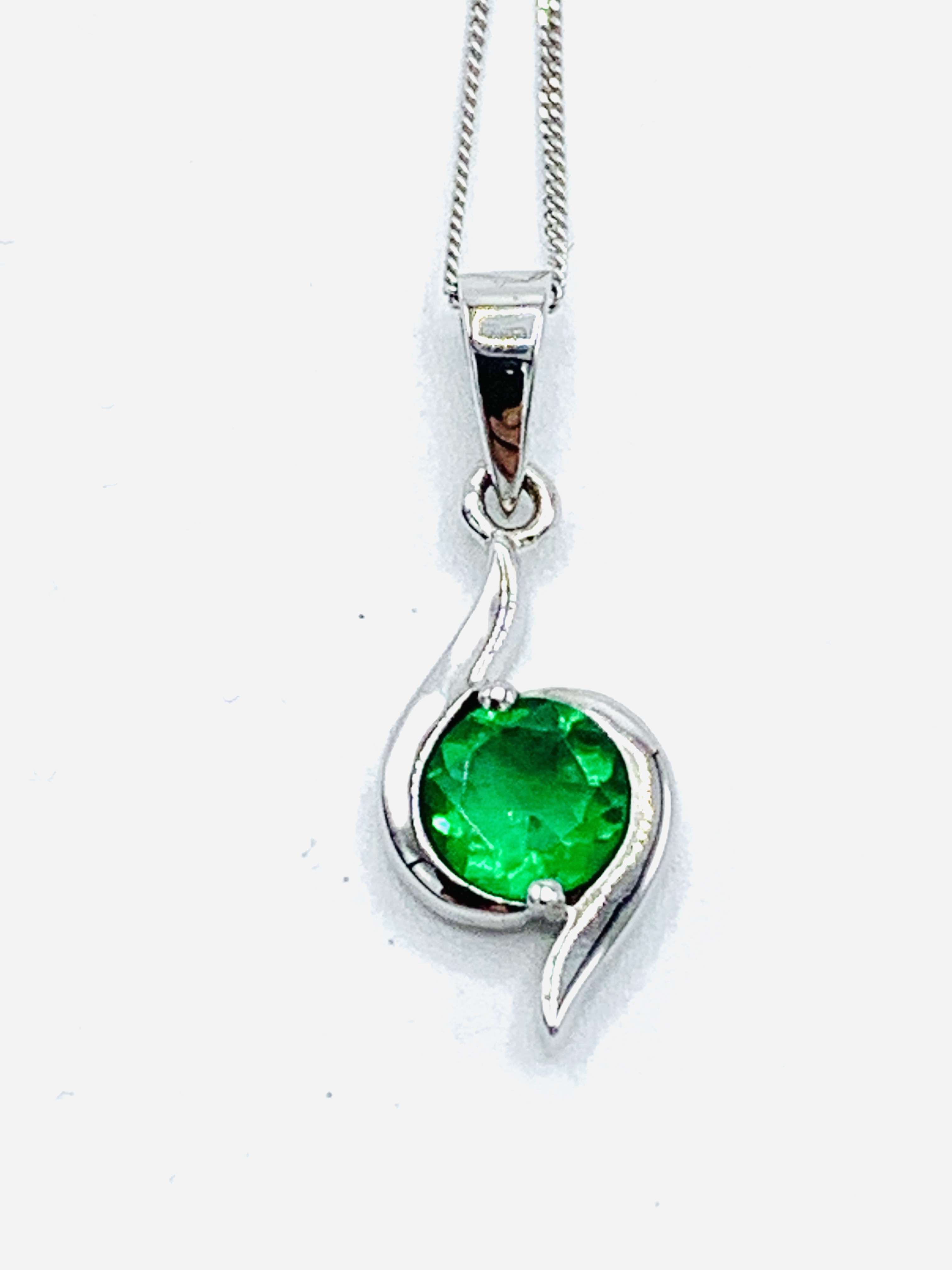 9ct white gold and green stone pendant on a 9ct white gold chain